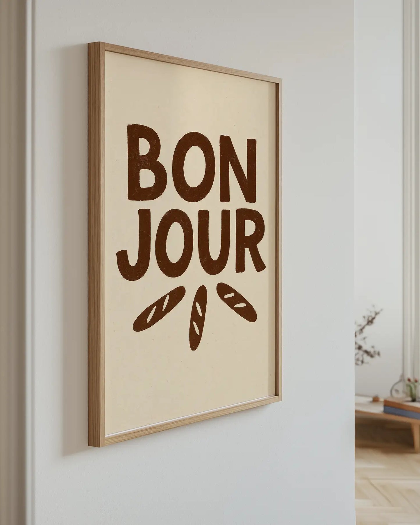 Artwork with 'Bonjour' text and bread illustrations on a wall.