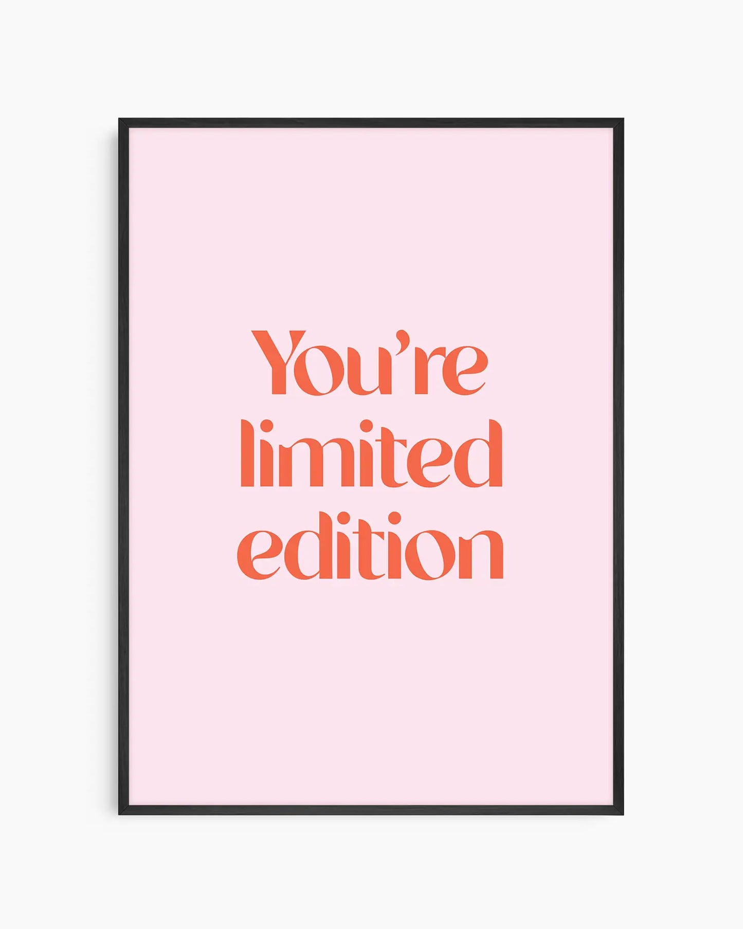 Children's poster with red text 'You're limited edition' on a pink background framed in a black frame.