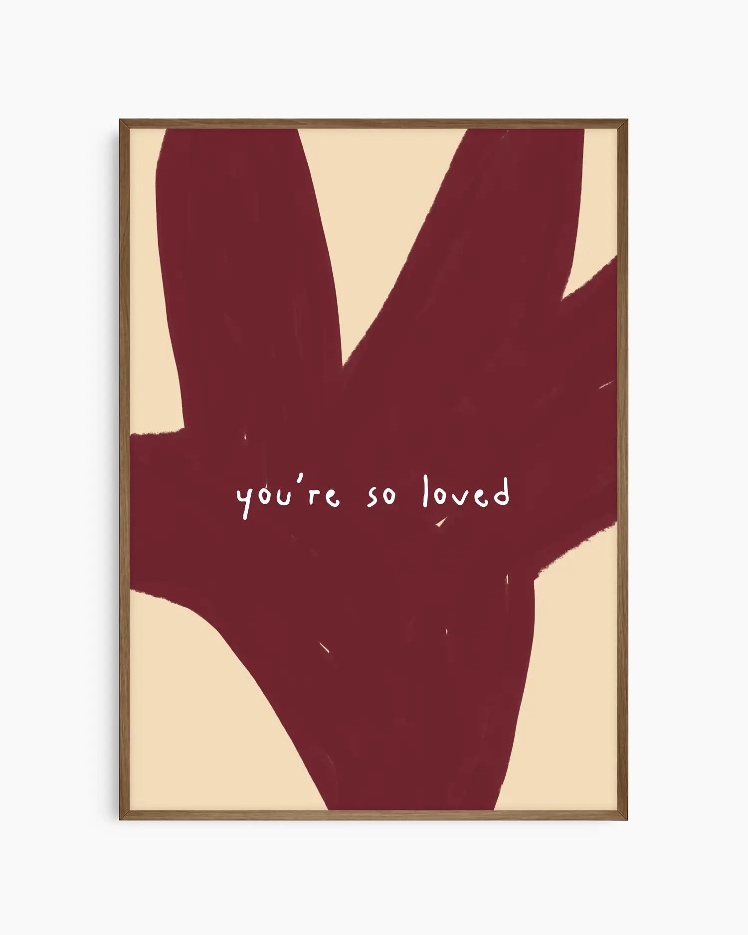 Red and beige nursery poster with the text 'you're so loved' framed in a dark oak frame.