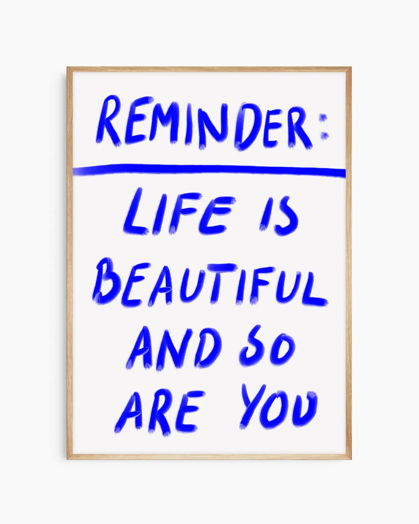 Framed poster with motivational quote 'Reminder: Life is beautiful and so are you' in blue text on a white background