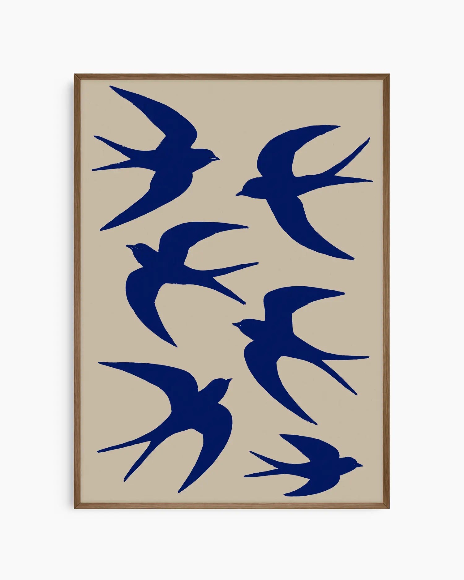 Framed artwork with blue bird silhouettes on a beige background