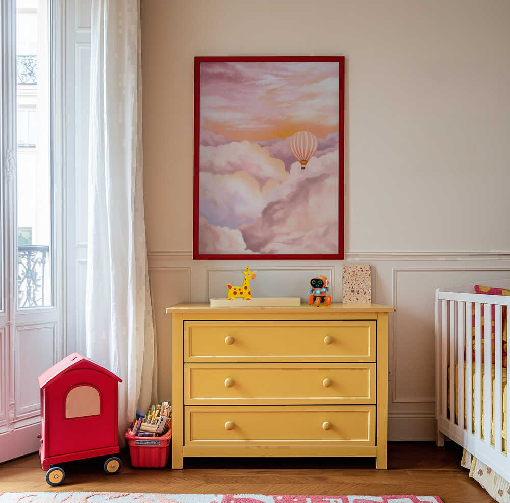 Whimsical hot air balloon wall art in dreamy pink and orange tones, hanging above a yellow dresser in a playful children’s room. A charming and imaginative print that inspires adventure and creativity.