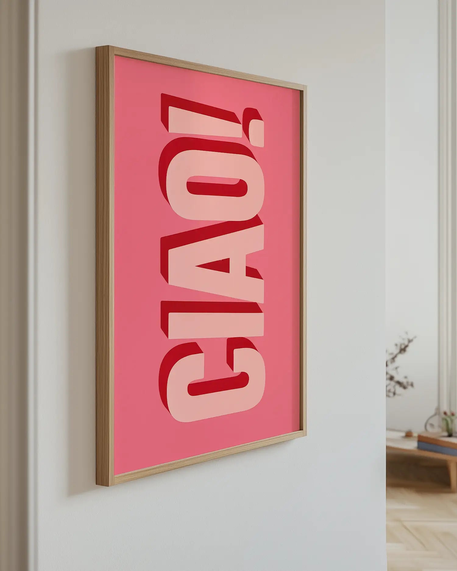 Artwork with 'CIAO!' on a pink background in a room setting.