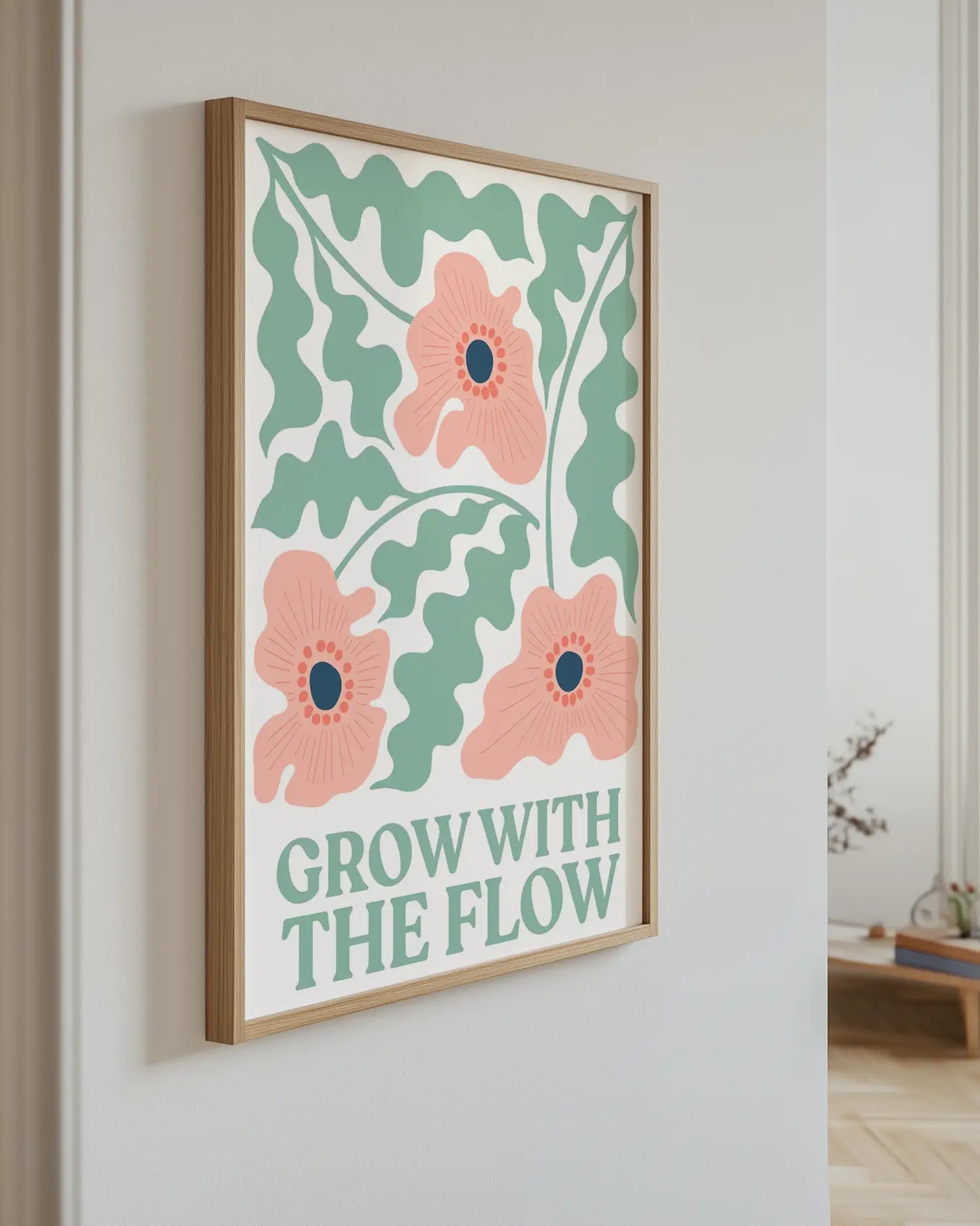Artwork with floral design and 'Grow with the Flow' text on a wall.