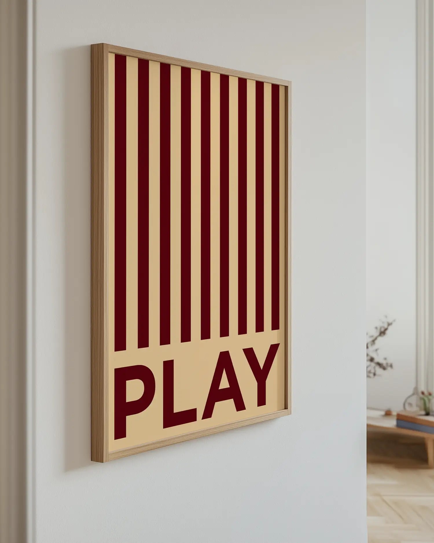 Artwork with red and beige vertical stripes and the word 'PLAY' on a white wall.