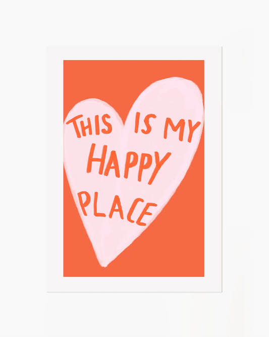 Heart-shaped sign with 'This is my happy place' text on an orange background