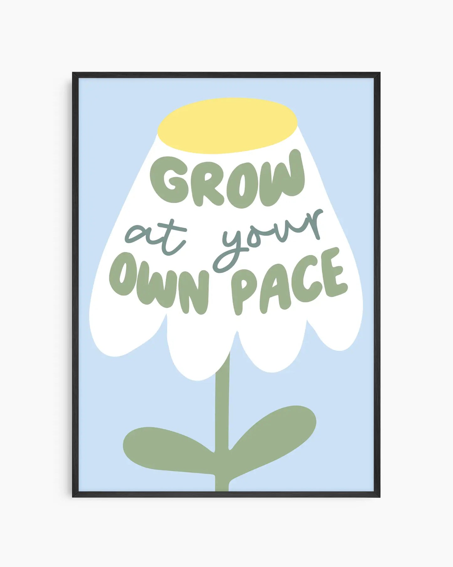 Framed artwork with a flower illustration and text 'Grow at your own pace' on a light blue background.
