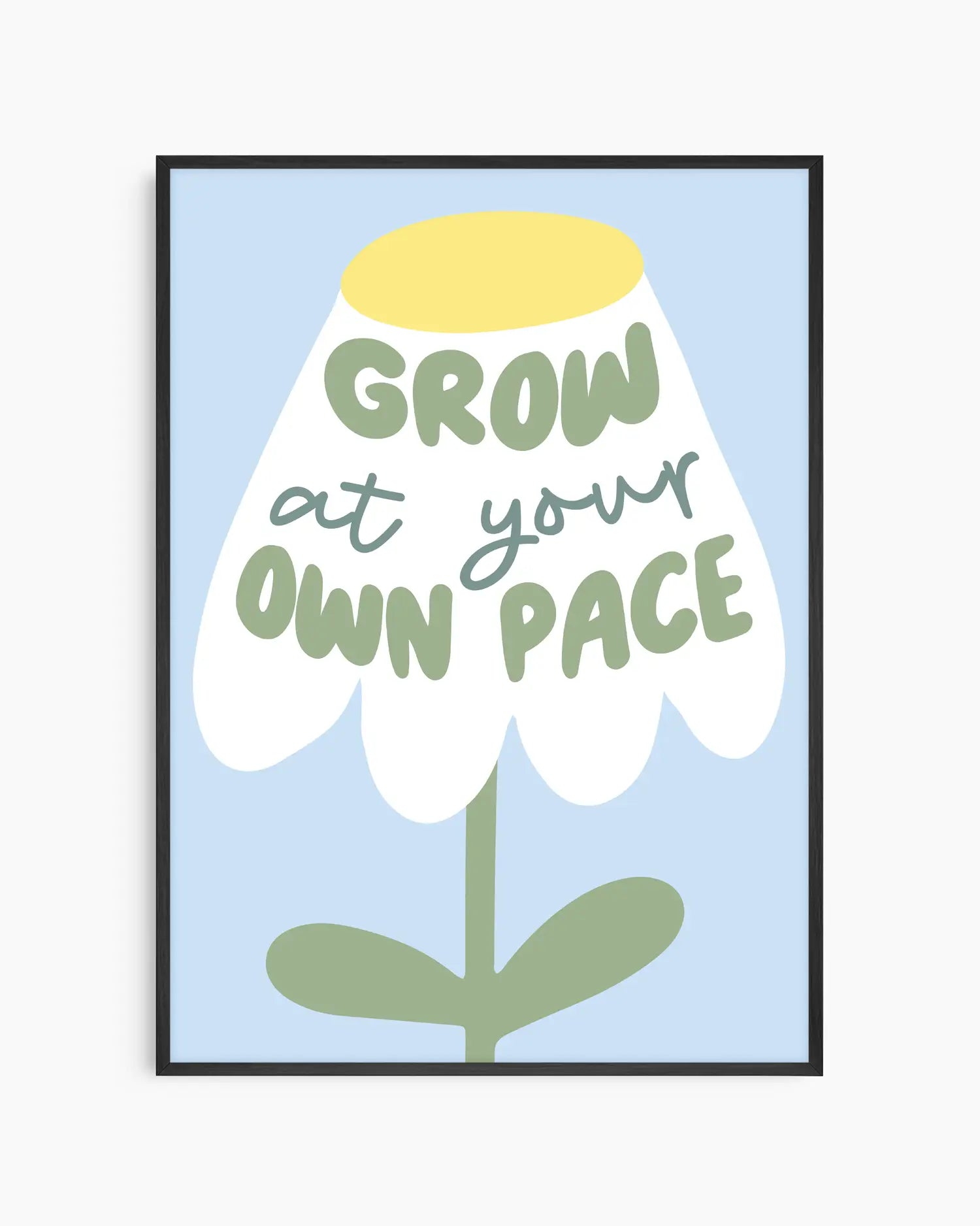 Framed artwork with a flower illustration and text 'Grow at your own pace' on a light blue background.