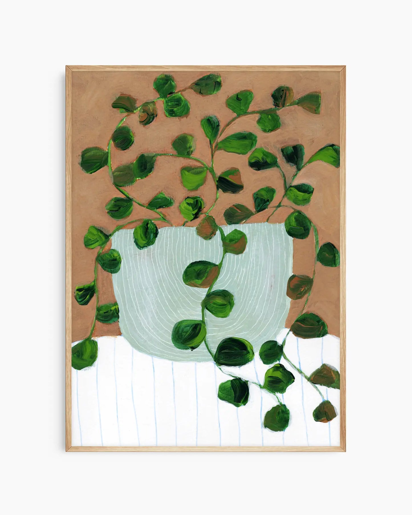 Framed artwork of a green leafy plant with a white pot on a brown background