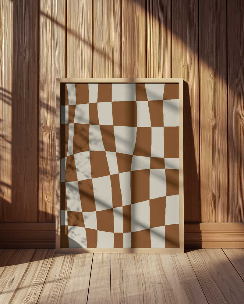 Modern abstract art print featuring a wavy brown and beige checkerboard pattern. Displayed in a light wooden frame leaning against a wooden wall, with warm sunlight and shadows. Minimalist geometric wall art perfect for Scandinavian or mid-century decor.