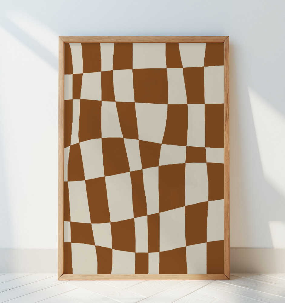 Contemporary checkerboard poster in warm brown and cream tones, framed in light wood and leaning against a white wall. A stylish and modern art print that adds movement and texture to any living room or hallway decor.
