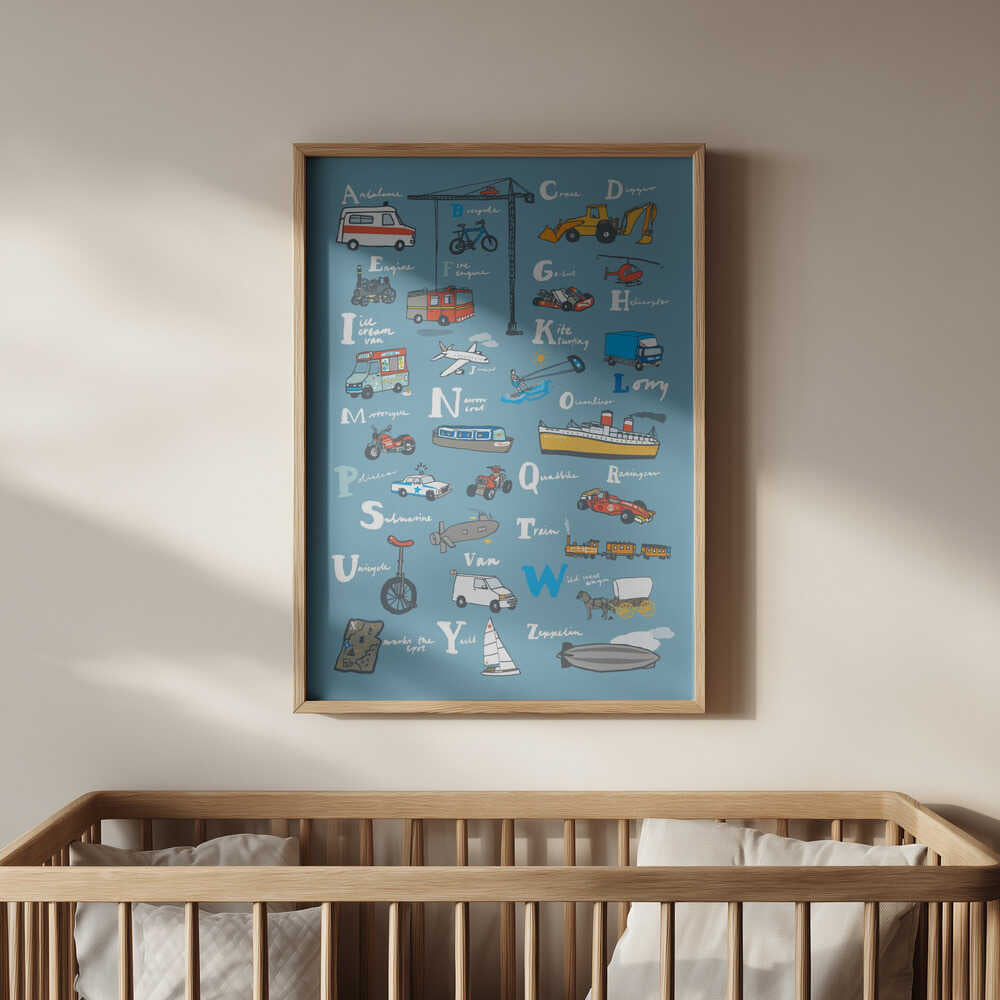 Cute A–Z vehicle poster with cars, bikes, planes, and ships on a soft blue background, framed in light wood and hanging above a baby’s crib. Perfect for a transportation-themed nursery or as a playful wall decor piece for little explorers.